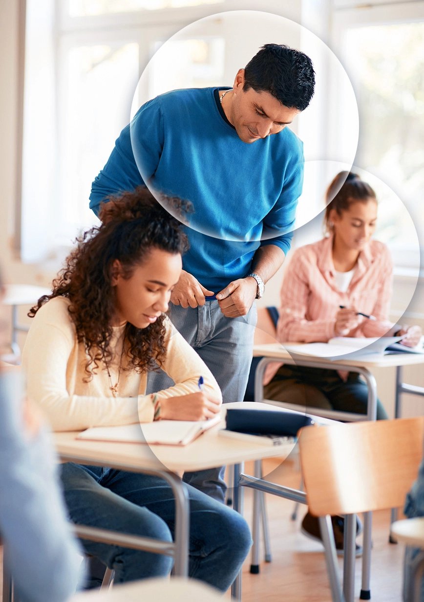 Male middle school teacher working with student